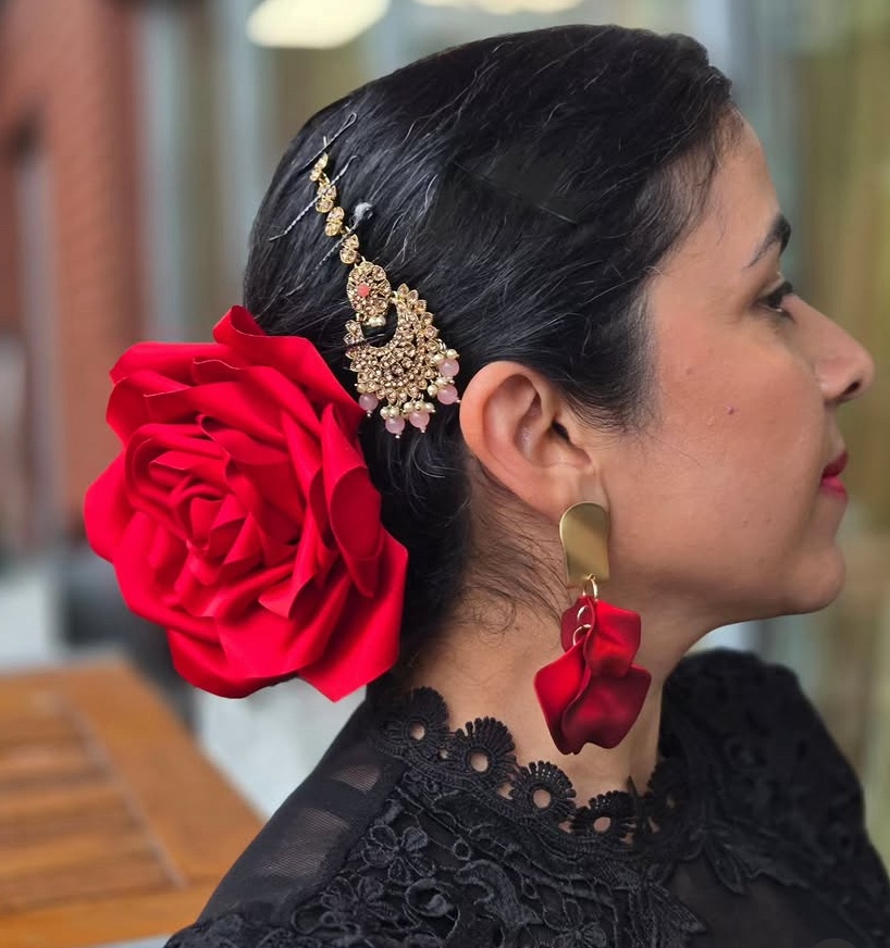 Michela with red flamenco flower and gold jewelry