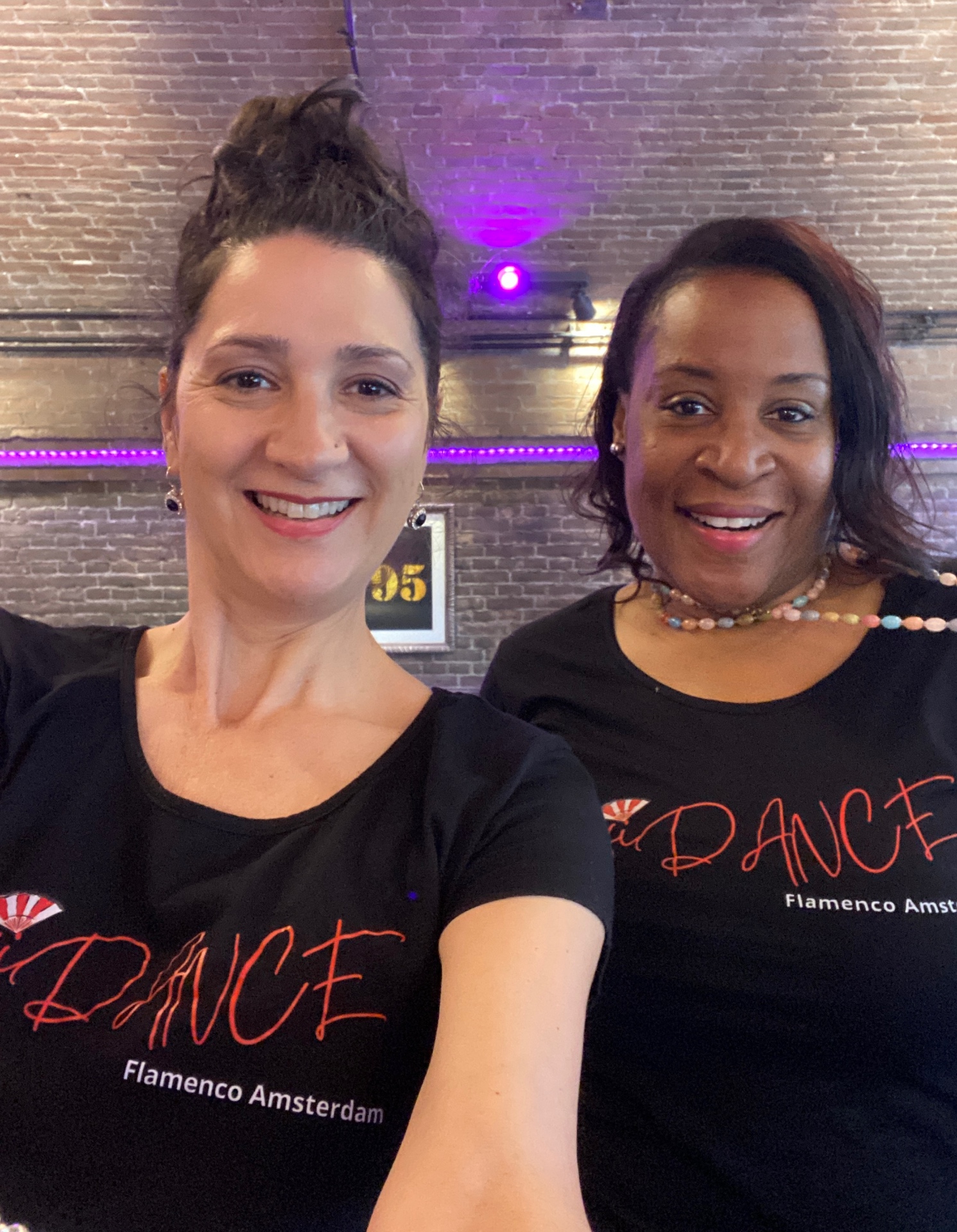 Two students wearing Flamenco ConfiDANCE™ shirts in the studio